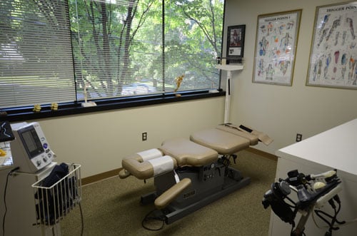 A second examination room with an exam table and clinical supplies