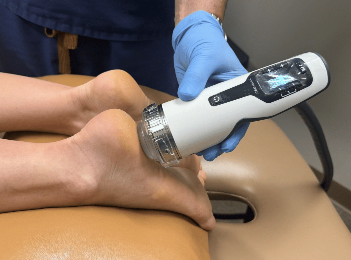 Shockwave therapy being applied to a patient by a clinician