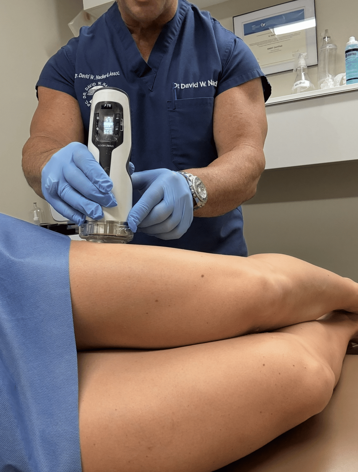 Clinician administering shockwave therapy treatment to a patient